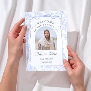 May include: A blue and white baptism program with a floral design. The program includes a photo of Jesus, the text "Welcome to the Baptism of", and the date and time of the baptism.
