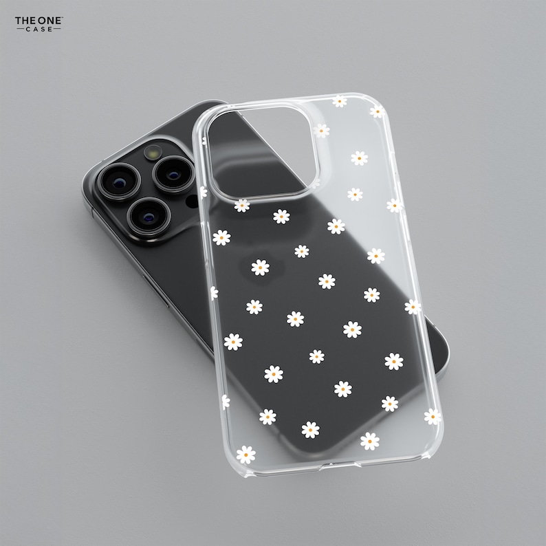 May include: A clear phone case with a white daisy pattern. The case is designed for an iPhone.