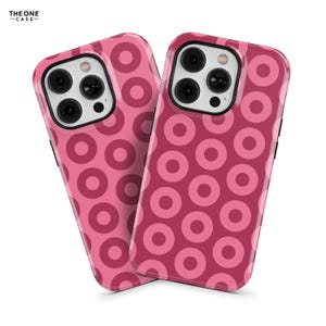 May include: Two pink iPhone cases with a donut pattern. The cases are made of a durable material and have a sleek design.