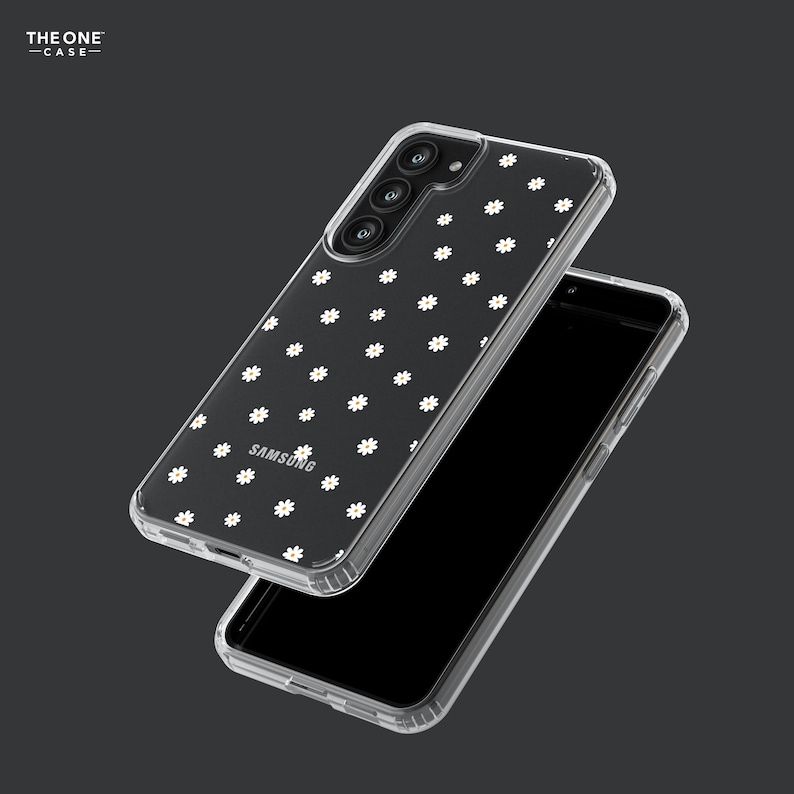 May include: A clear phone case with a white daisy pattern. The case is designed for a Samsung phone and has a raised camera bump.