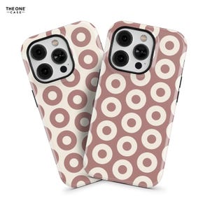 May include: Two phone cases with a white background and a pattern of pink circles. The cases are designed for an iPhone 13 Pro Max.