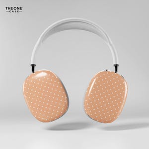 May include: White and tan polka dot headphones with a white headband. The earcups are tan with a pattern of small white dots. The text "THE ONE -CASE-" is in the upper left corner.