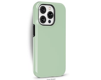 May include: A sage green phone case with a black border. The case has a cutout for the camera lens.