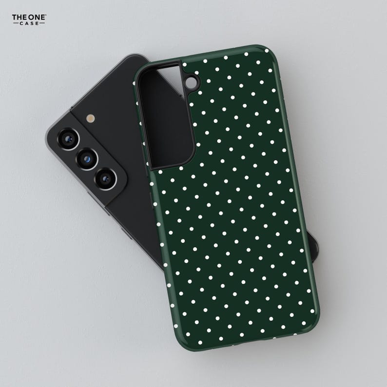 May include: A green phone case with a white polka dot pattern. The case is shown on top of a black phone.