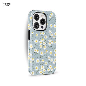 May include: A light blue phone case adorned with a daisy floral design. The case displays white daisies with yellow centres and green stems. The brand name "THE ONE -CASE-" is printed in the upper left corner.