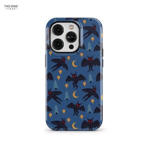 May include: A blue phone case featuring a repeating pattern of black moth-like creatures with red eyes, yellow stars, crescent moons, and green trees. The case has a glossy finish and a camera cutout.