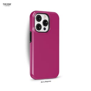 May include: A pink phone case with a silver camera lens. The case is labelled "Berry Magenta".