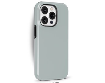 May include: A seafoam grey phone case with a black border and a camera lens cutout. The case is designed for a smartphone with a triple camera system.