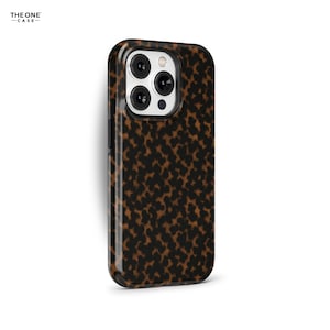 May include: A glossy phone case with a brown and black leopard print pattern. The case has a camera cutout and the brand name "THE ONE CASE" is printed in the top left corner.