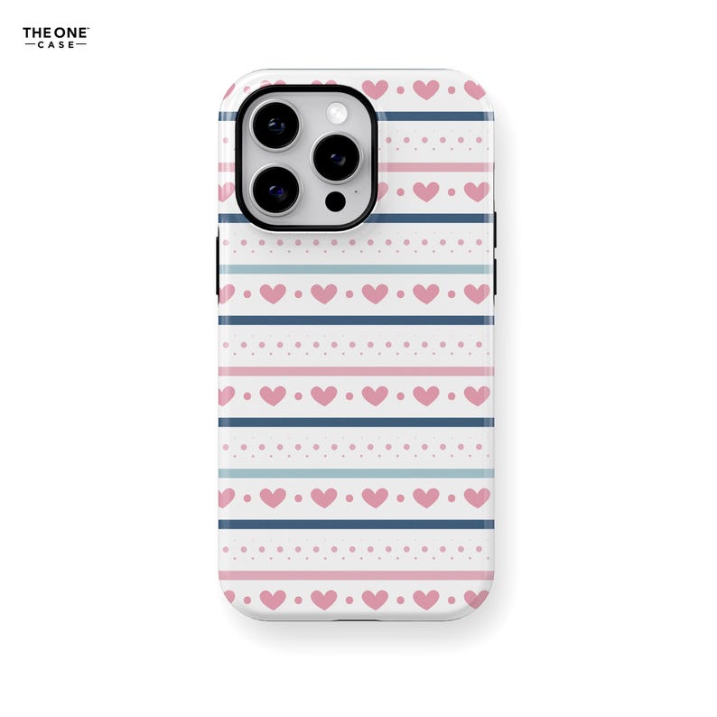 May include: A white phone case with a pink and blue striped pattern and small hearts. The case has a cutout for the camera lens.