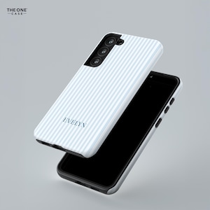 Pode incluir: Uma capa de telefone listrada em branco e azul claro com o nome "EVELYN" em azul marinho. A capa do telefone &eacute; mostrada ao lado de um smartphone preto. A marca "THE ONE CASE" est&aacute; no canto superior esquerdo.