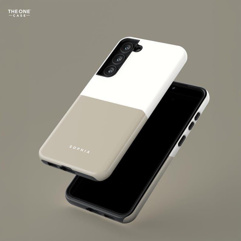 May include: A two-tone phone case in white and beige, with the name "SOPHIA" printed on the beige section. The case is shown with a black smartphone, and the text "THE ONE CASE" is in the upper left corner.