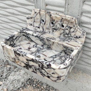 Bespoke Calacatta Viola marble sink with violet veining and a matching backsplash, ideal for luxury bathrooms.