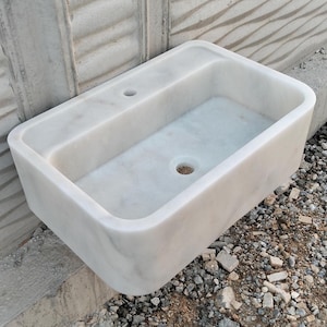 Luxurious Carrara marble sink with a polished finish, adding sophistication to any space.