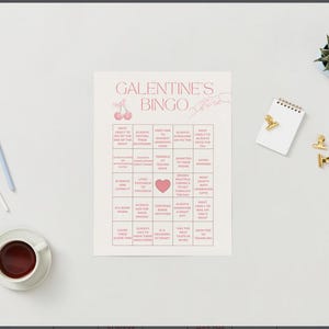 May include: A pink and white Galentine's Bingo card with squares containing phrases like "Always the designated driver" and "Most likely to always have a backup plan".