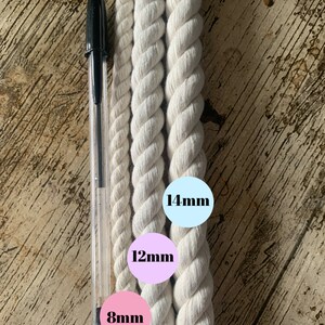 May include: Three white cotton ropes of different thicknesses, measured in millimeters. The ropes are laid out side-by-side on a wooden surface. The smallest rope is 8mm, the middle rope is 12mm, and the largest rope is 14mm.