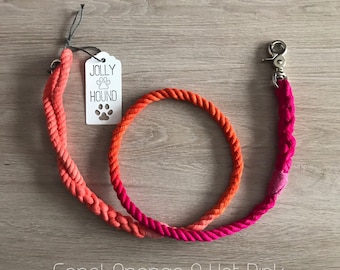 May include: A coral, orange, and hot pink dog leash with a white tag that says "Jolly Hound" and a silver clasp.
