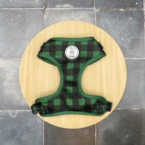 May include: Green and black plaid dog harness with a white circle logo that says "Jolly Hound".