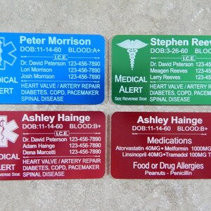 May include: Four blue, green, red, and red medical alert cards with white text. The cards include the person's name, date of birth, blood type, emergency contact information, and medical conditions. The cards also include a star of life symbol.