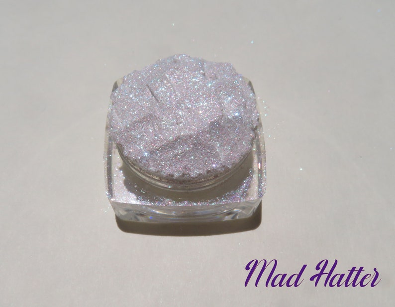 MAD HATTER - Sparkly Fine Eye Glitter Mineral Eyeshadow Shimmer Highlighter. Viewed in a single jar with name of eyeshadow in the corner in fancy purple font.