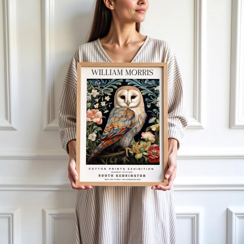 May include: A framed print of a white owl with blue and orange feathers sitting in a floral arrangement. The print is titled 'William Morris Cotton Prints Exhibition' with the text 'South Kensington' and the date 'MAR. 1920 TO MAY. 1920 ADMISSION FREE'.