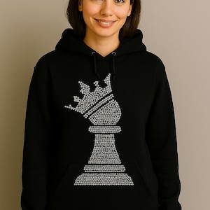 May include: Black hooded sweatshirt featuring a large, sparkling chess piece design on the front. The chess piece, a bishop, is rendered in a pattern of small, shiny embellishments. The sweatshirt has a kangaroo pocket and a drawstring hood.