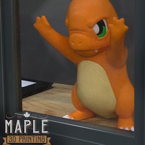 May include: A 3D-printed orange Charmander figure with a tan belly, white claws, and a green-eyed expression. The figure is posed with its arms raised. The Maple 3D Printing logo is visible in the lower left corner.