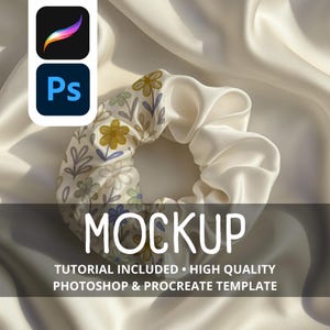 May include: A white satin scrunchie with a floral pattern featuring yellow and blue flowers. The scrunchie is a hair accessory and is shown on a white satin background. The image also includes the text "MOCKUP".