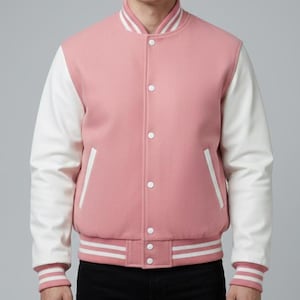 May include: A pink and white varsity jacket with a button-up front, white sleeves, and a striped collar and cuffs. The jacket has two front pockets and a ribbed hem with white stripes.