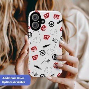 May include: White phone case featuring a racing design with red and black elements. The pattern includes racing flags, helmets, the number 87, and bear graphics. The text "Additional Color Options Available" is on a blue banner.