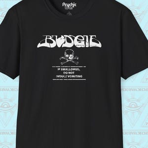 May include: A black short-sleeve t-shirt featuring a white graphic print. The design includes the word BUDGIE in a stylized font above a skull and crossbones icon, followed by the text IF SWALLOWED, DO NOT INDUCE VOMITING in white capital letters.
