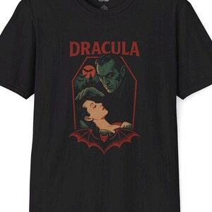 black shirt featuring Classic horror illustration of Dracula, coffin, bats, castle, bat