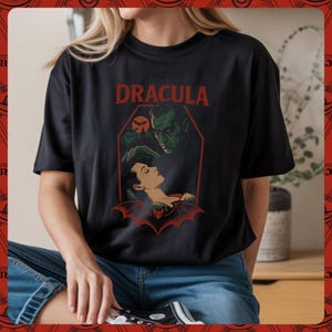 Woman wearing black shirt featuring Classic horror illustration of Dracula, coffin, bats, castle, bat