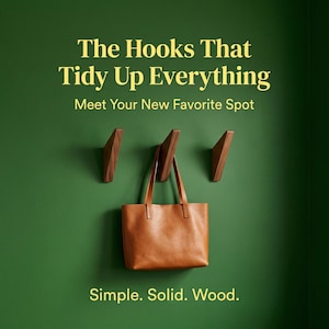May include: Three wooden wall hooks with a brown leather tote bag hanging from one. The hooks are mounted on a green wall. Text on the image reads: "The Hooks That Tidy Up Everything. Meet Your New Favorite Spot. Simple. Solid. Wood."