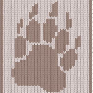 May include: A knitted pattern featuring a large bear paw print. The paw is in shades of brown, set against a light beige background. The design is framed by a border of the same light beige color.