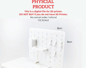 May include: A white 3D-printed pegboard, measuring 8cm x 6cm, with attached hooks and storage compartments. The text "NOT A PHYSCIAL PRODUCT" and other instructions are visible. This is a digital file for 3D printer.
