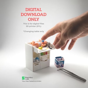 May include: A miniature white changing table with a baby figurine, a box of diapers, and tweezers. The text "DIGITAL DOWNLOAD ONLY" and "Changing table only" are visible. The Bambu Lab logo is also present.
