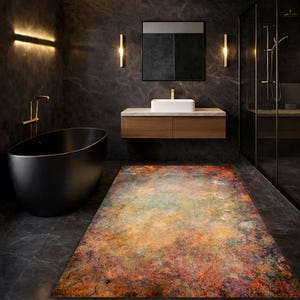 May include: A rectangular bathroom rug with an abstract design in shades of orange, brown, green, and blue. The rug is placed in a modern bathroom with a black bathtub, wooden vanity, and dark grey walls.