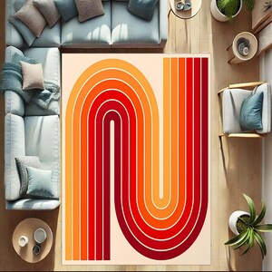 May include: A rectangular area rug with a retro design. The rug features a repeating pattern of curved lines in shades of red, orange, and yellow against a cream background. The rug is placed on a wooden floor, surrounded by furniture.
