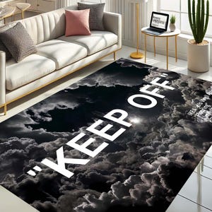 May include: Black and white area rug with a cloud pattern and the text "KEEP OFF" in large white letters.