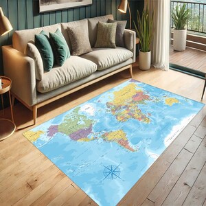 May include: A rectangular area rug featuring a world map design. The rug has a light blue background with a detailed depiction of continents in various colors. A compass rose is in the lower center. The rug is on a hardwood floor.