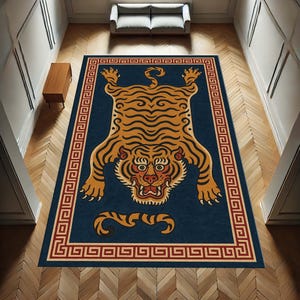 May include: A rectangular rug with a navy blue background features a stylized tiger design in shades of orange and black. The tiger is centered, surrounded by a red and gold Greek key border. The rug is placed on a wooden floor.