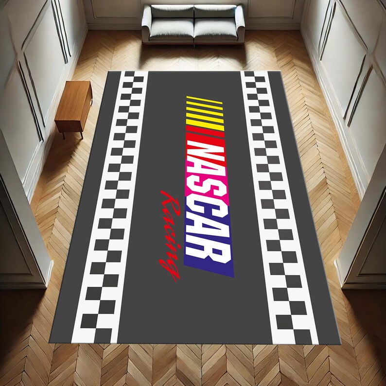 May include: A grey and black chequered rug with the words "NASCAR Racing" in colourful letters. The rug has a black border with white chequered squares.