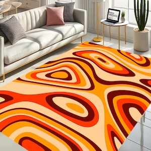 May include: Abstract area rug with a swirling pattern of orange, red, and brown on a cream background.
