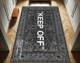 May include: A black and white patterned rug with the text "KEEP OFF" in white lettering. The rug is made by IKEA in collaboration with Virgil Abloh.