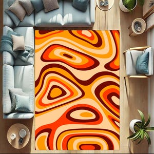 May include: Abstract area rug with a swirling pattern of orange, yellow, and brown. The rug has a modern, geometric design.