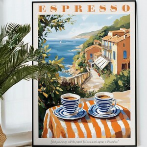 May include: A vintage-style poster with the word "ESPRESSO" in orange letters. The poster features a colorful illustration of a seaside town with a cafe table and two cups of coffee. The text at the bottom reads "Start your morning with the perfect Italian moment - espresso in the sunshine!"
