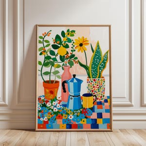 May include: A colorful painting featuring a blue moka pot, a yellow mug, and three potted plants including a lemon tree, a sunflower, and a snake plant. The objects sit on a vibrant, multi-colored checkered tablecloth covered in small floral patterns.