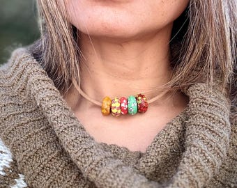 Beaded necklace with recycled glass from Ghana and leather cord.