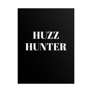 Op de afbeelding: Een zwarte achtergrond met de witte tekst "HUZZ HUNTER" in een vetgedrukte, schreefletter. De tekst is gecentreerd en beslaat het grootste deel van de afbeelding.